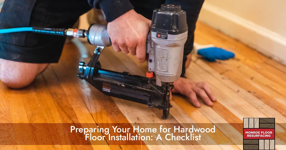 a contractor installing a hardwood floor with a power tool