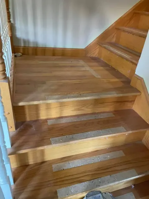 Hardwood floor installation in progress with new boards fitted across a room