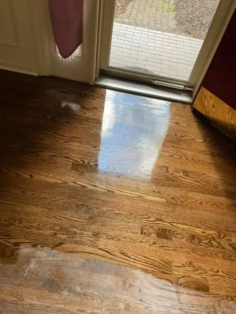 Completed hardwood floor installation in a bright Rochester NY living space
