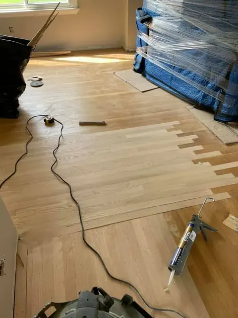 Hardwood flooring installation detail showing tight board joints and clean edges