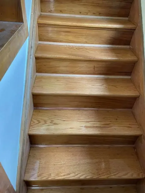 Newly installed hardwood flooring along a hallway in a Hilton NY home