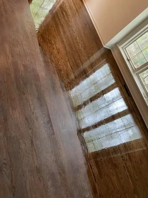 Refinished hardwood flooring with rich grain detail in a Rochester area home