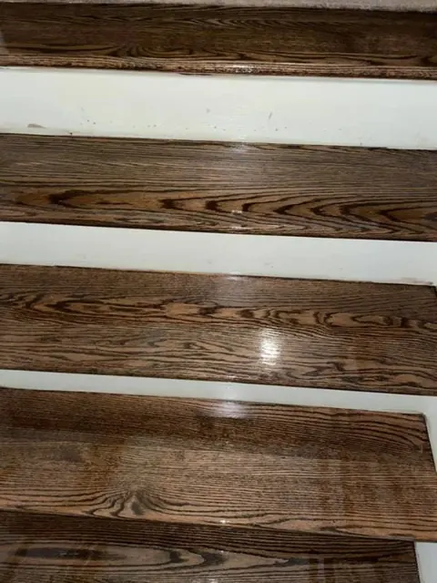 Gleaming dark-stained hardwood stairs after professional refinishing