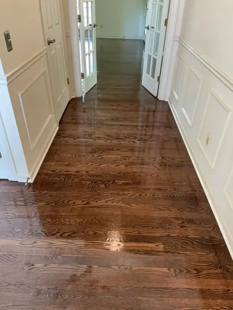 Sunlit room with newly refinished light hardwood floors