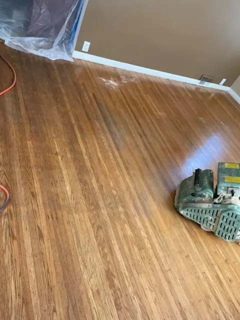 Finishing touches during hardwood floor installation by Monroe Floor Resurfacing
