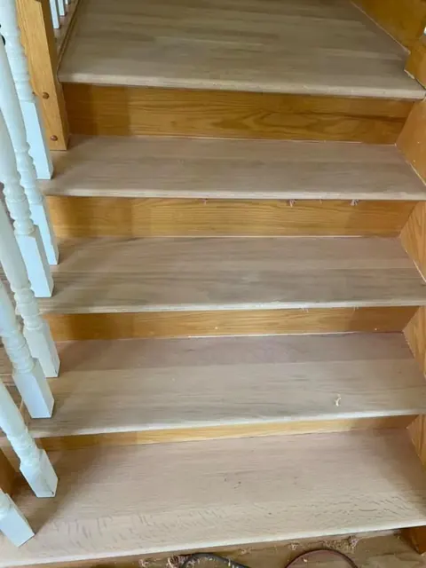 Bare wood stairs before staining during hardwood refinishing project in Rochester NY
