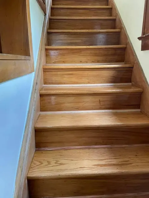 Completed staircase after hardwood staining and refinishing in Rochester NY