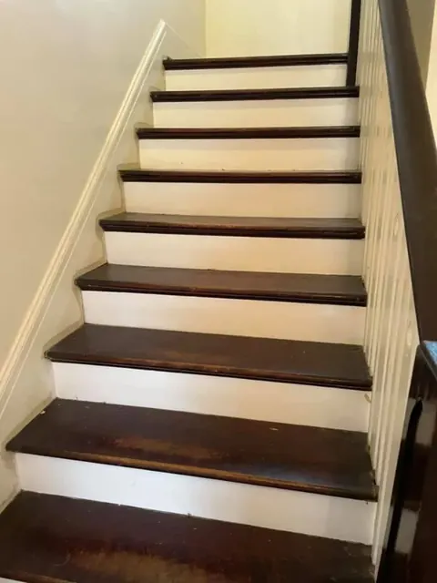 Entryway with refinished hardwood floors and polished wood grain detail