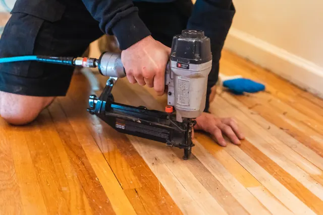Hardwood floor sanding underway in a Rochester NY home prior to refinishing