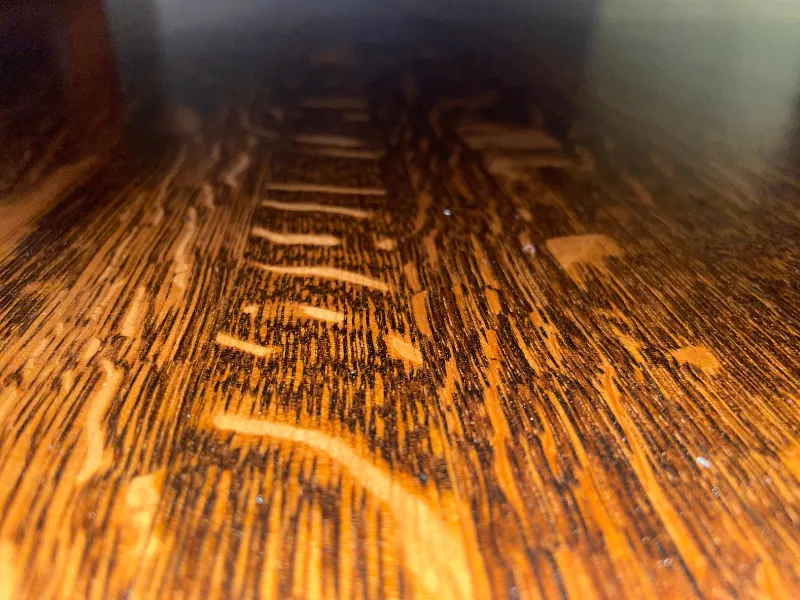 worker refinishing hardwood stairs